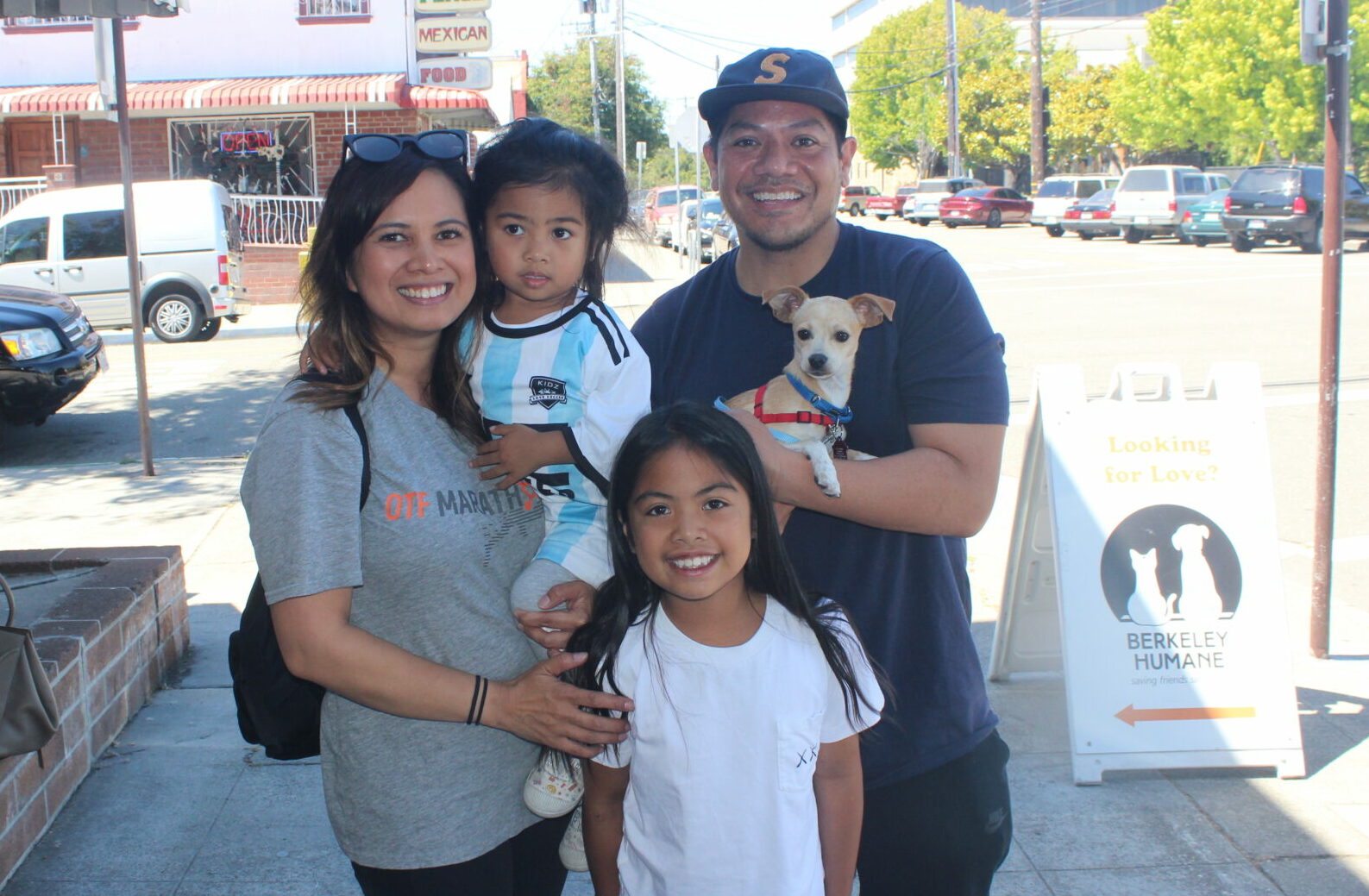 Happy family of five with two girls and a newly adopted dog