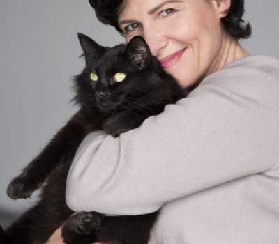 image of woman holding a long-haired black cat